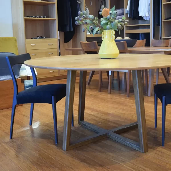 The Darling round wooden dining table with geometric timber legs and a round timber top custom designed by Buywood Furniture, joinery in Brisbane.