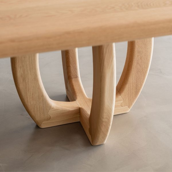 Crafted by Buywood Furniture from solid hardwood the Banksia dining table features a curved jigsaw mitre joint base and framed rounded top.