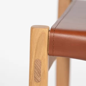 Custom designed and crafted by Buywood Furniture, the Kimberley Dining Chair is fitted with belt straps as a unique design feature.