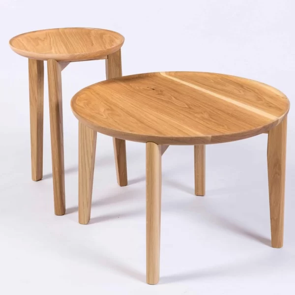 The Tully Side Table designed and crafted by Buywood Furniture featuers rounded tapered legs with a cross base supporting the dished-out round top.