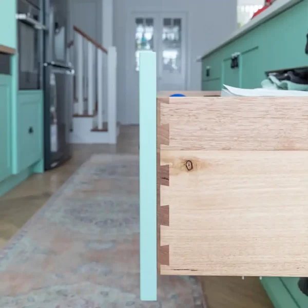 This farmhouse timber kitchen is ergonomically designed with solid wood doors and dovetail joints in drawers painted in a very trendy pastel mint green.