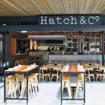 A hospitality fit out for Hatch & Co, Newstead. Buywood Furniture joinery crafted custom bar tables built to last and stand the test of time.