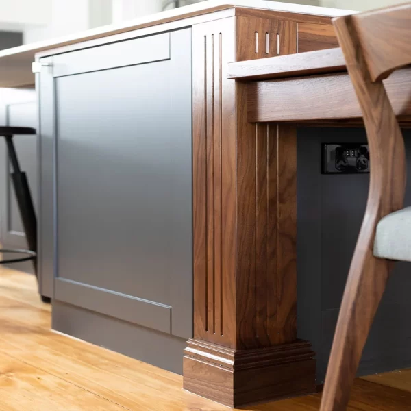 This custom Walnut dining suite was crafted for an impressive kitchen benchtop from Black Walnut featuring fluting, slightly wider and tapered leg details and built into the kitchen bench.