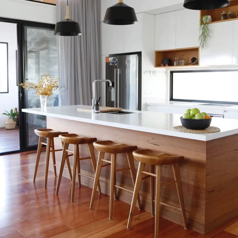 The timber surround of this kitchen benchtop was custom built by Buywood Furniture and series of alcoves was built from Blackbutt timber.