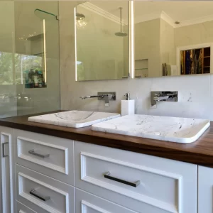 Custom timber bathroom vanity with double basins, mirror cabinets designed & installed by Buywood Furniture.