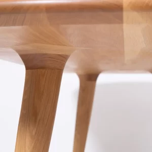 Custom designed and crafted by Buywood Furniture, the Arial dining table features tapered rounded-square legs as well as complex knuckle-inserts.