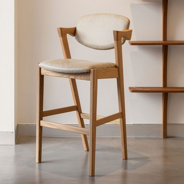 The Kai Stool, a harmonious blend of Danish design handcrafted from your choice of premium solid hardwood timber, boasts an upholstered seat and backrest.