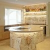 Entertainment kitchen area that seamlessly blends Sydney Sandstone, the warmth of American Oak, and the exquisite touch of brass drawer handles.