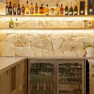 LED lighting to illuminate these floating shelves, Natural Sydney Sandstone and American Oak used in this beautiful kitchen.