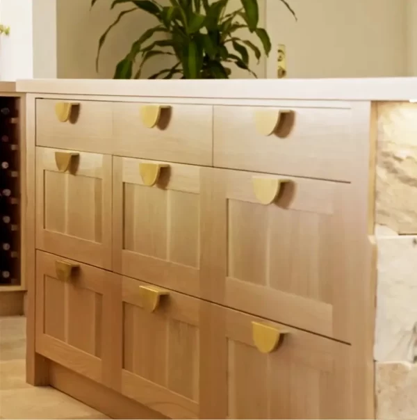 Exquisite touch of brass drawer handles for this island bench created from American Oak and Natural Sydney Sandstone.