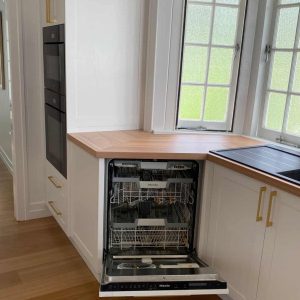 Integrated appliances for this custom designed luxe kitchen with integrated appliances, and Blackbutt timber benchtops by Brisbane joinery Buywood Furniture